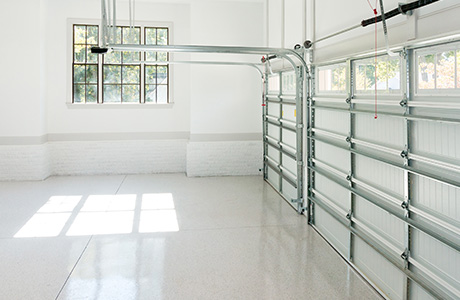 Garage interior with white floors white walls and window.