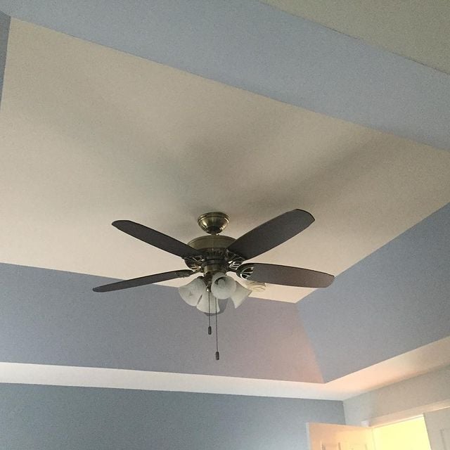 Angled tray ceiling accented in SW Windy Blue