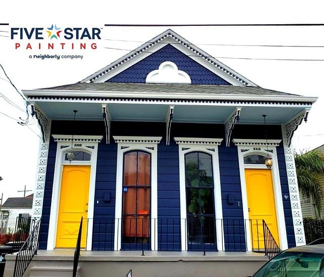 blue house with white accents and yellow doors