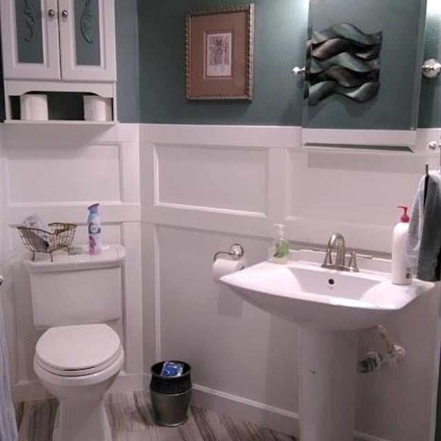 Teal and white bathroom with wainscoting