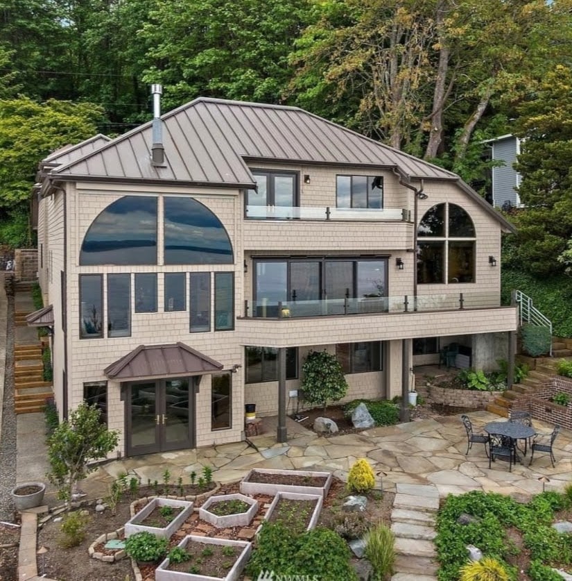 Three Story Home with metal roof and landscaping