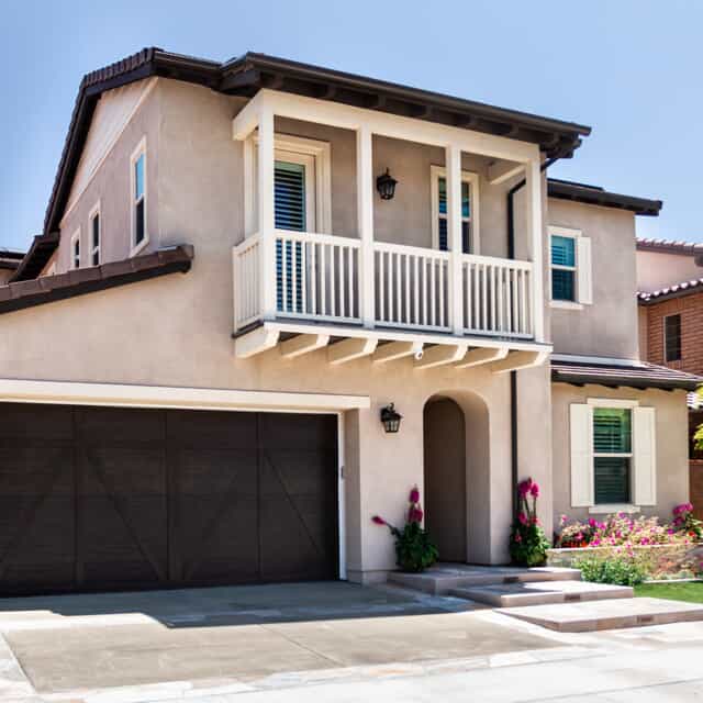 Beige two-story home with balcony