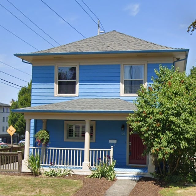 Historical Home with Front Porch Railings and Pillars