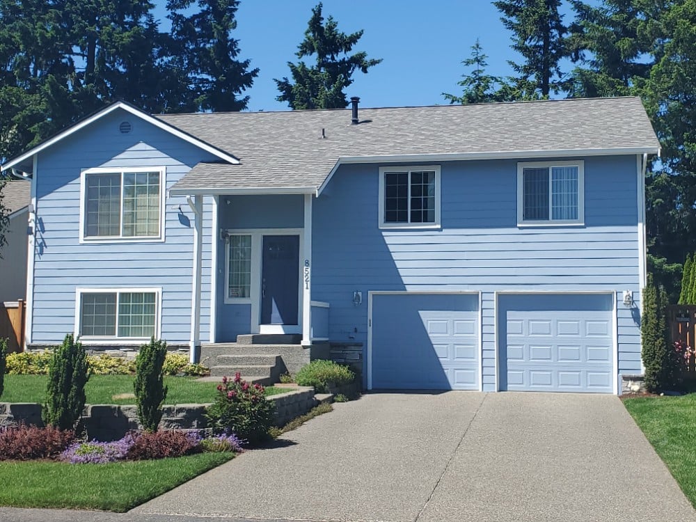 Two Story home with two single car garage doors and visible front door