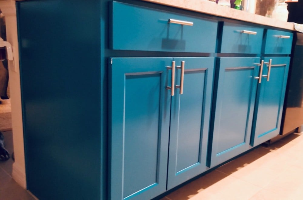 Blue painted kitchen cabinets beautifully transformed by our expert residential and commercial painting team at Five Star Painting, adding a stylish and modern touch to any home's interior design