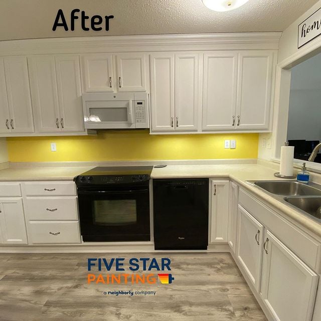 Cabinet painted a light cream with yellow backsplash