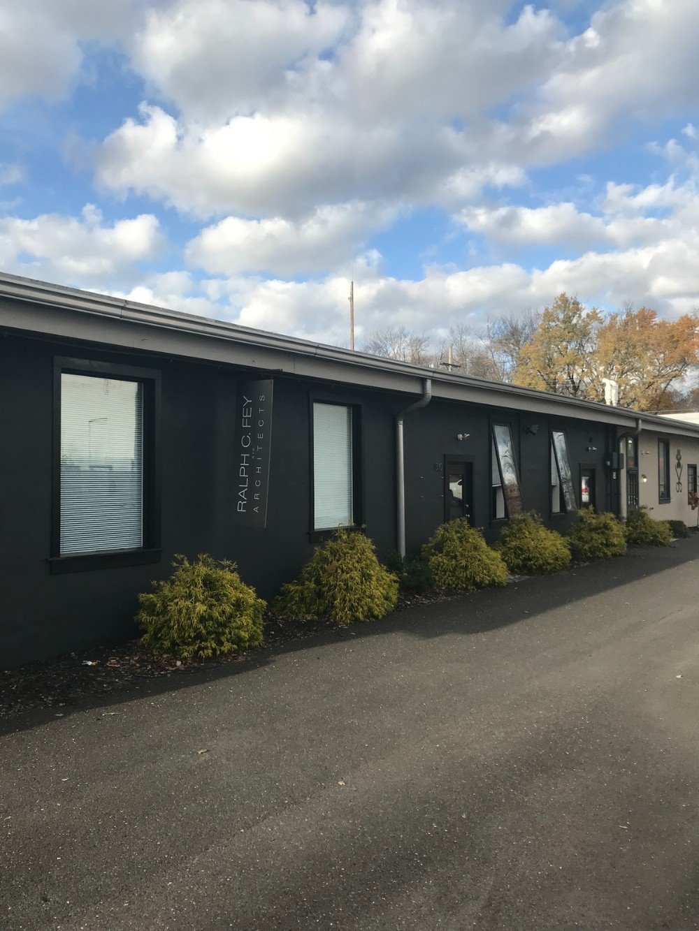 on story commercial building dark gray black windows