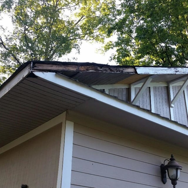 Damaged wood on rooftop.