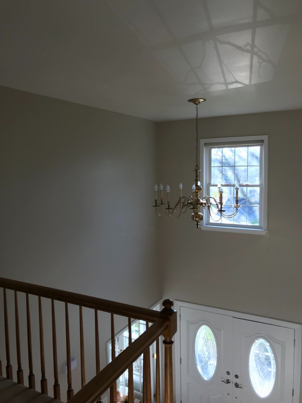 Beige walls two story entrance window brown railings