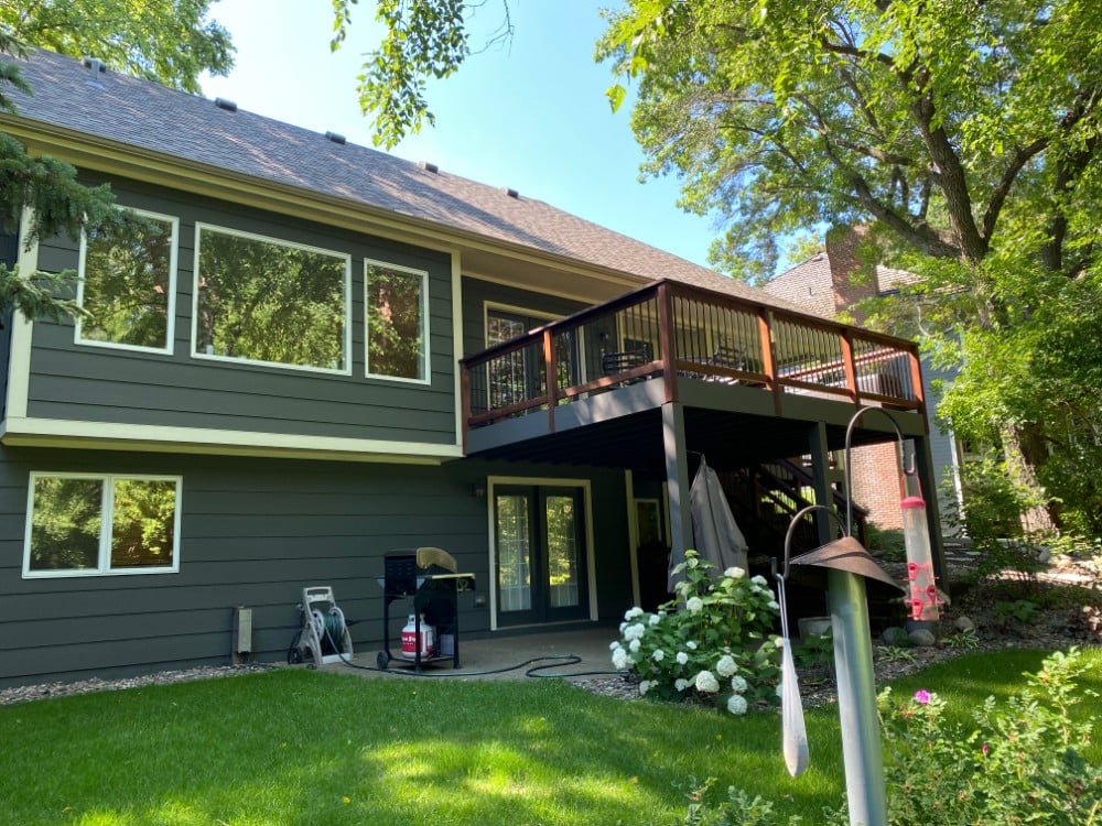 Rear side of green house with deck