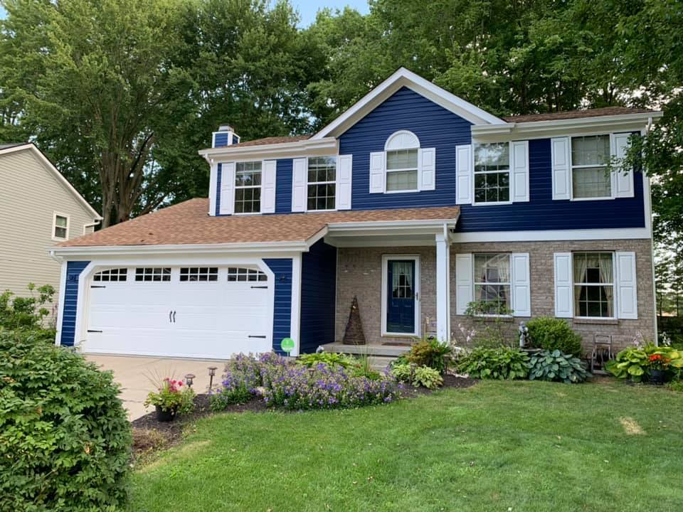 Expert painters skillfully refreshing the entire exterior of a local Pittsburgh home, enhancing its curb appeal and protecting it from the elements