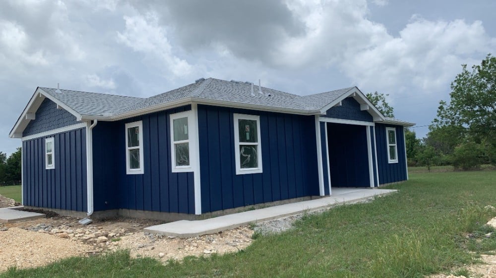 Classic barn structure showcasing a vibrant blue body with crisp white trim, highlighting the exceptional quality of our Five Star Painting services in Wexford, PA