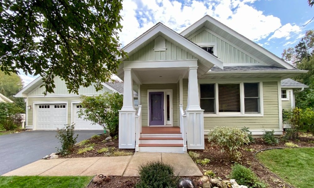 Light green house with purple front door