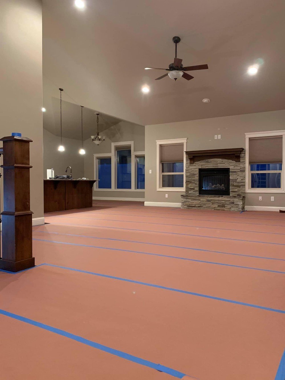 Living room floor masking prep for painting