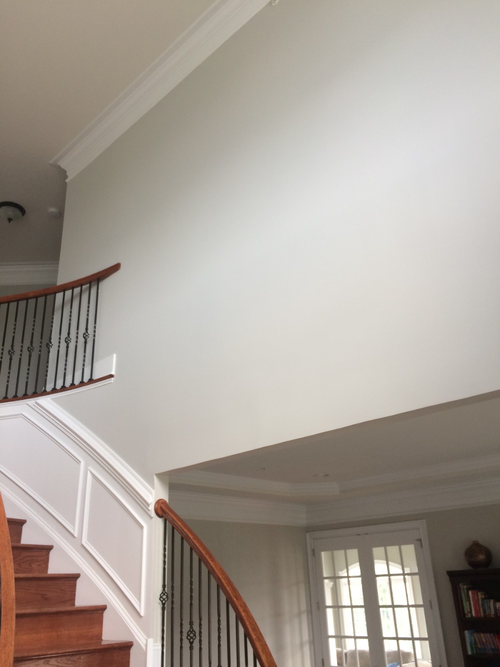 Light Gray foyer walls white trim wood stairs