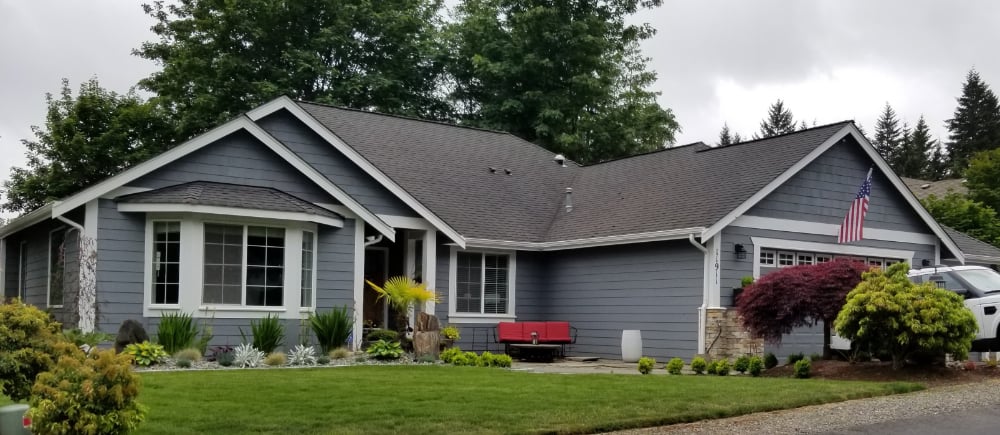 One Story Home with landscaping and double car garage door