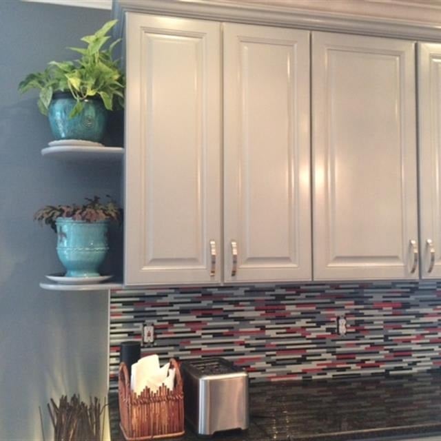 Grey kitchen cabinets with modern multicolored backsplash