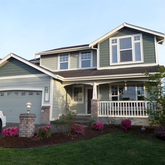 Two Story Home with Front Porch Railings and Posts