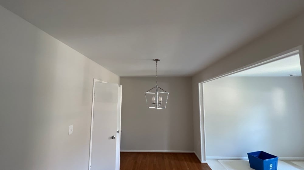 Grey Renewed Grey Dining Room with Contrasting White Trim and New Chrome Lighting.