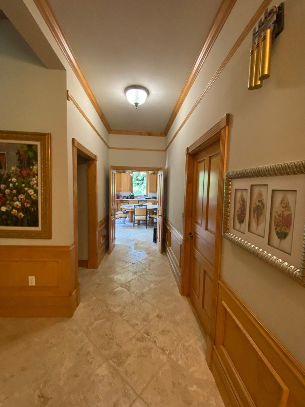 Hallway to Kitchen with Beautiful Crown Molding and Wainscoting