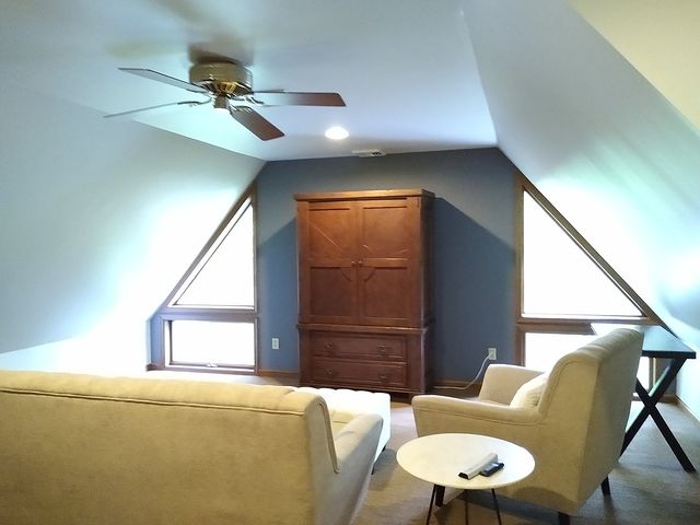 Home loft with couched and wood tv cabinet