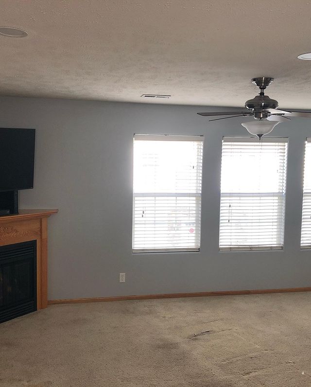 Interior painting in living room with natural wood trim