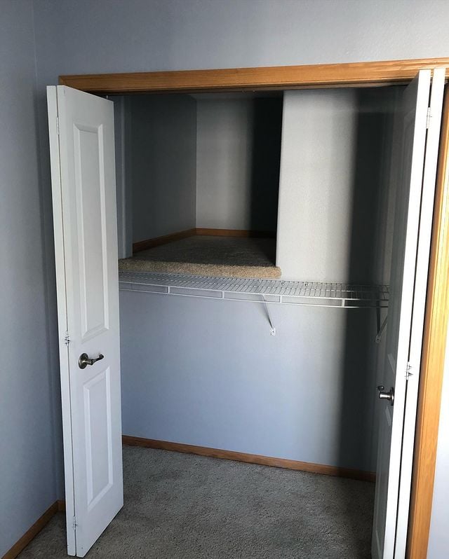 Interior painting inside closet with natural wood trim and hide away cubby