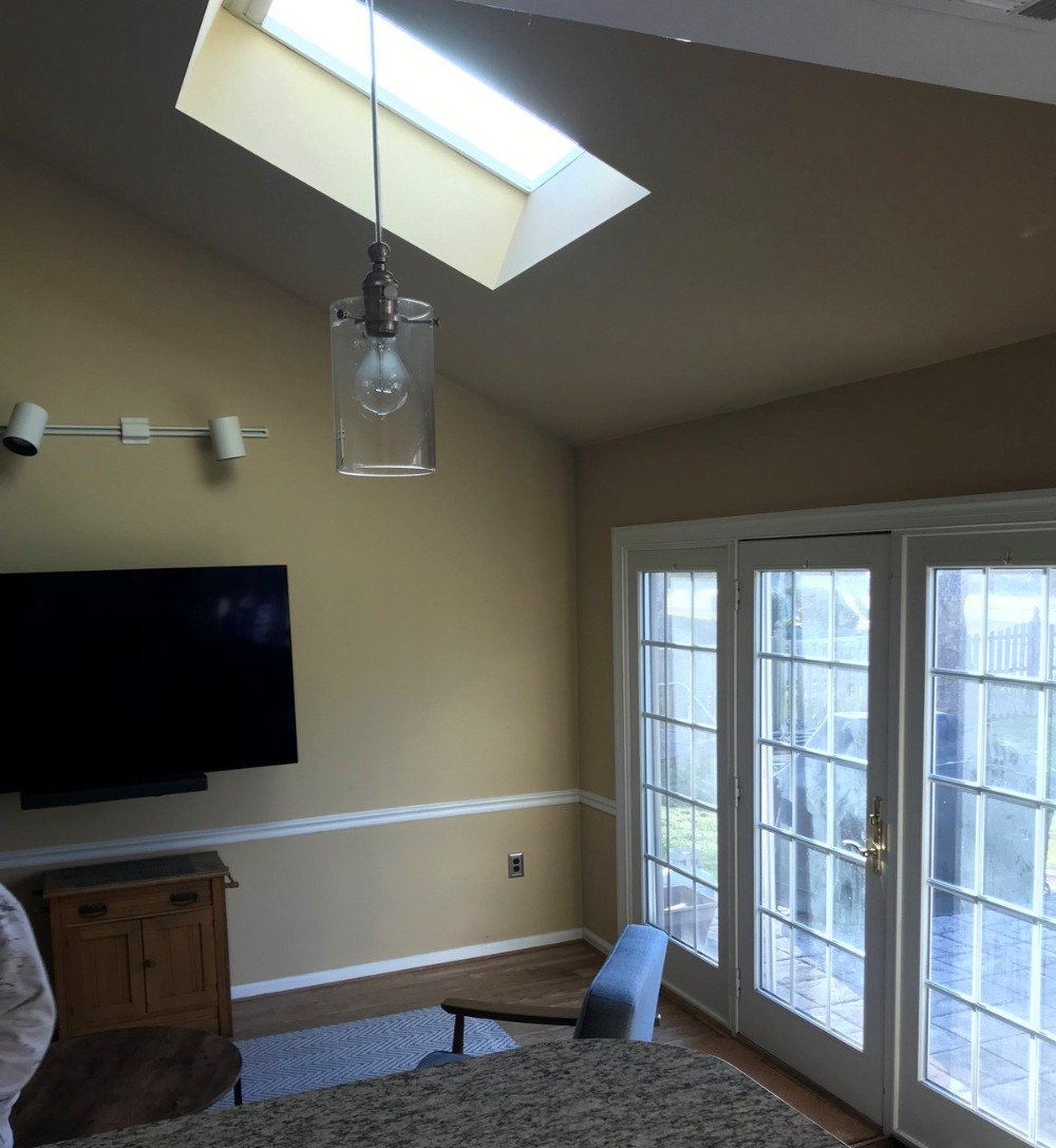 Kitchen painted walls in greige ceiling skylight white gloss trim television in eating area