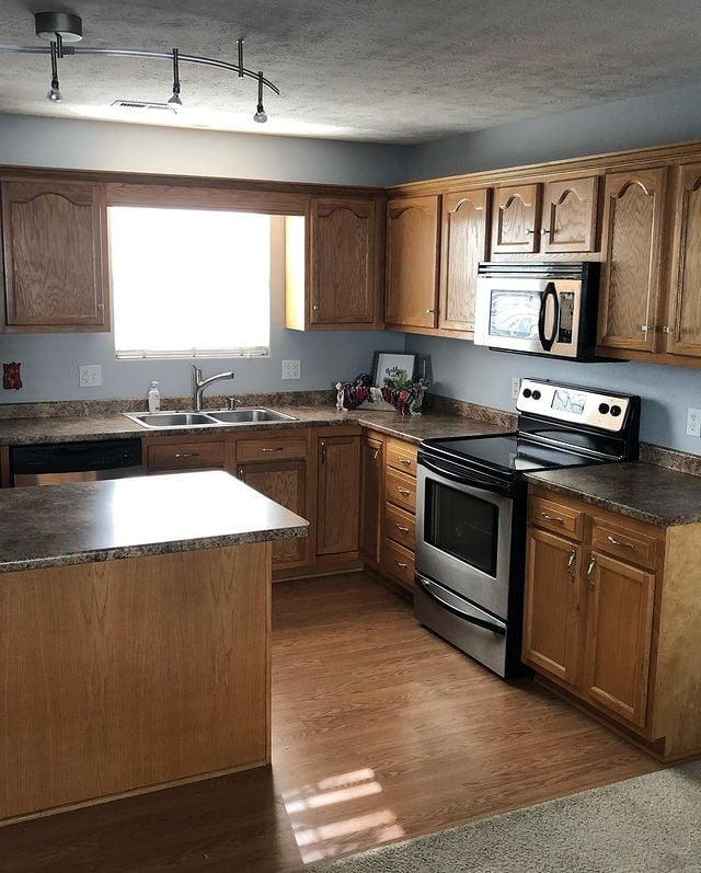 Kitchen with natural wood cabinets and painted walls