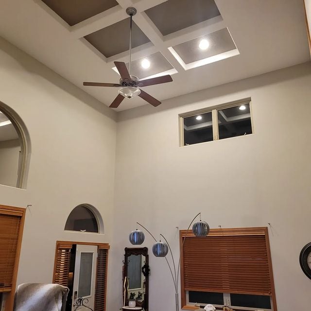 Living area with high ceiling and high windows