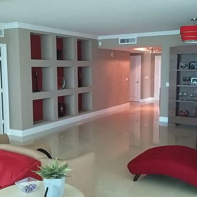 Living room with red furniture and beige walls 