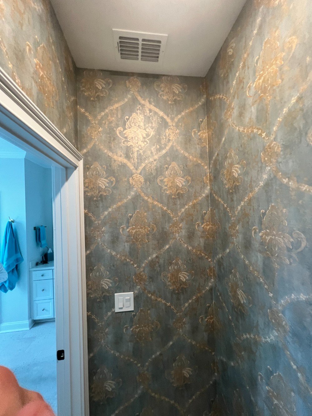 Wallpaper installed in a powder room.