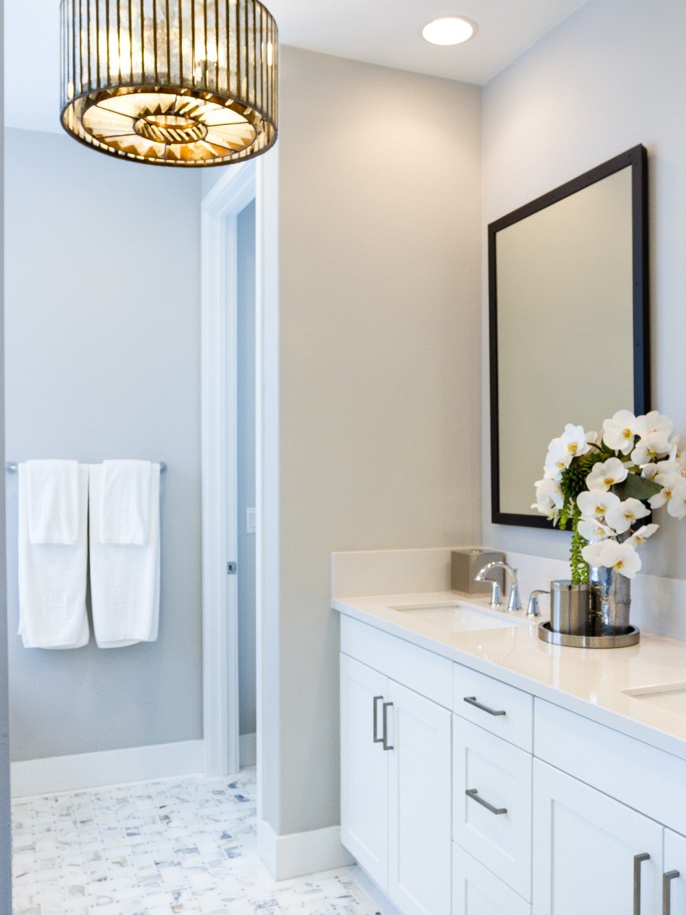 Stylish bathroom featuring white painted cabinets against sophisticated gray walls, showcasing the high-quality craftsmanship of our Five Star painting services in Pittsburgh, PA