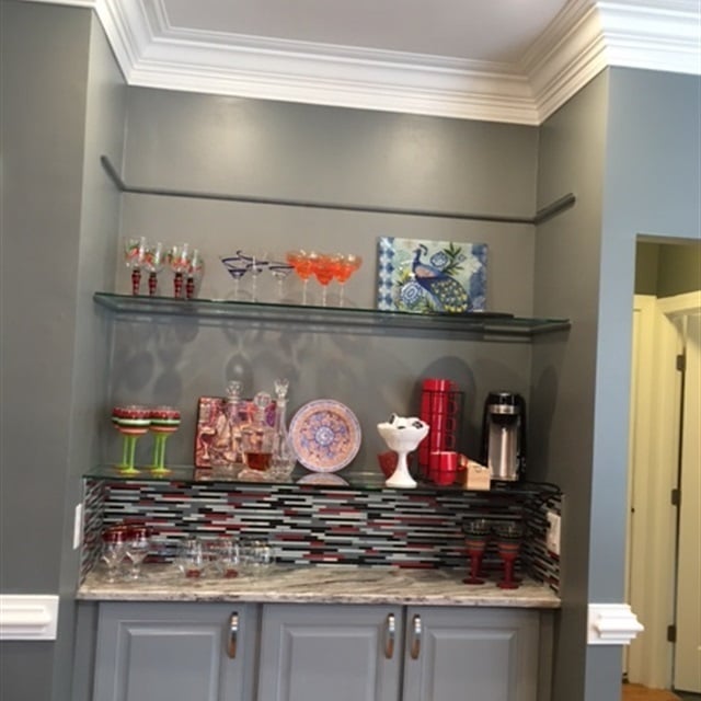 Painted grey kitchen cabinet with glass shelves