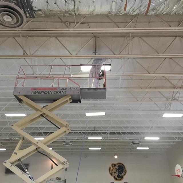 Painter working on rafters