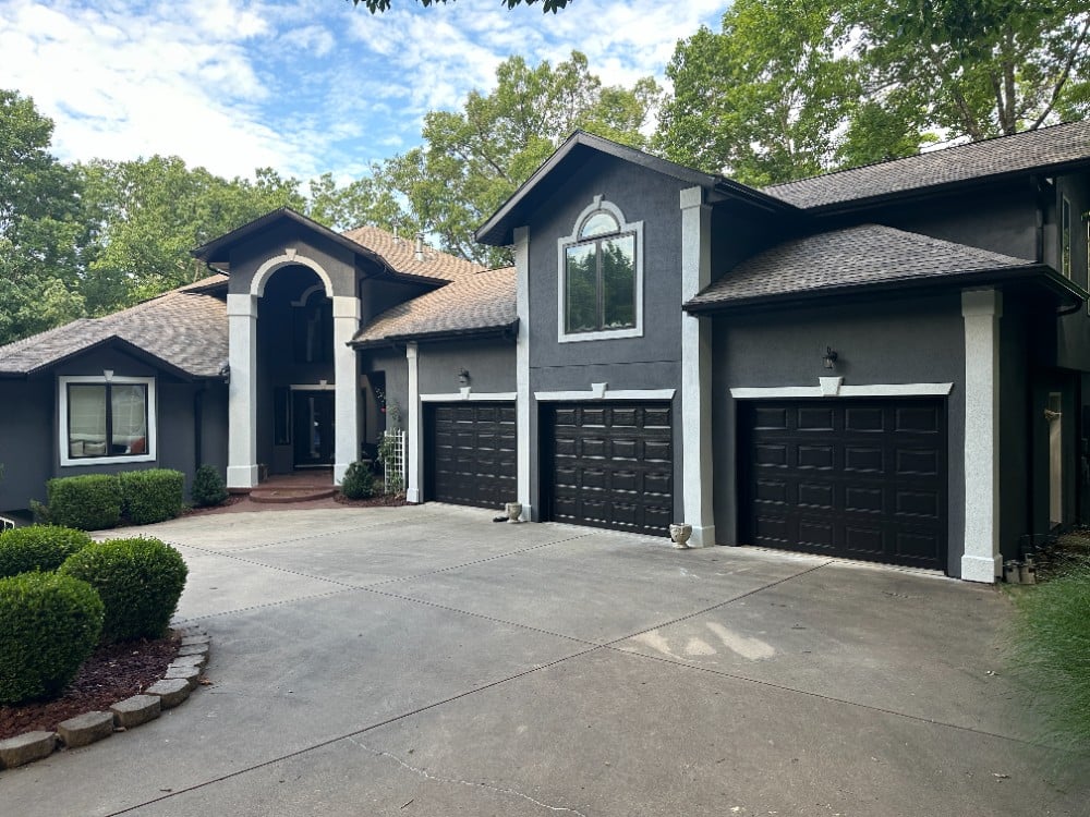 Residential stucco exterior repaint with white trim