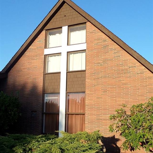 Arched Brick Church with White Cross