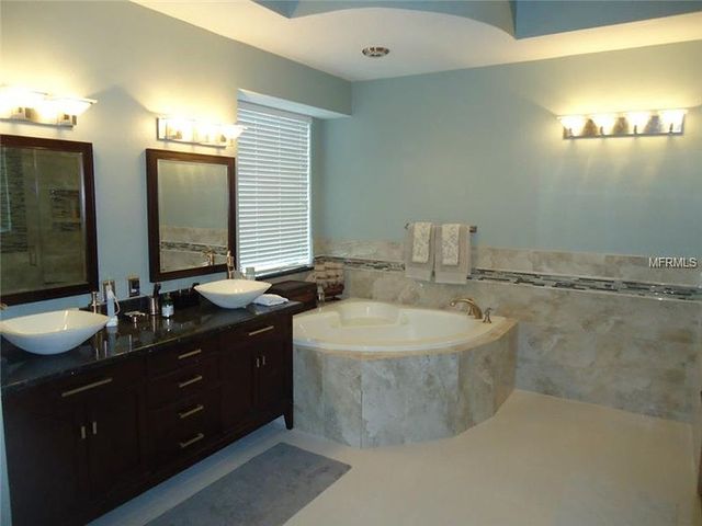 Tile bathroom with brown cabinet