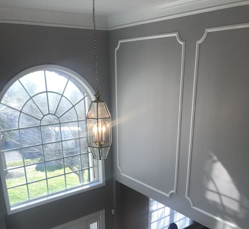 Two story foyer with gray walls and white trim