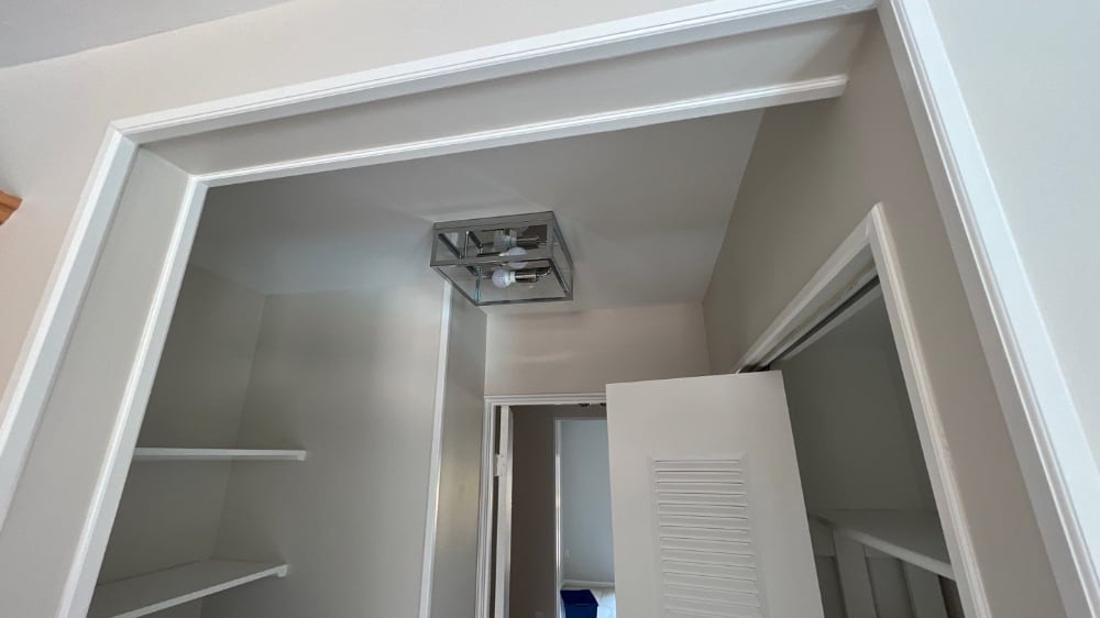 Updated Grey Pantry with High Contrast White Trim and Chrome Lighting