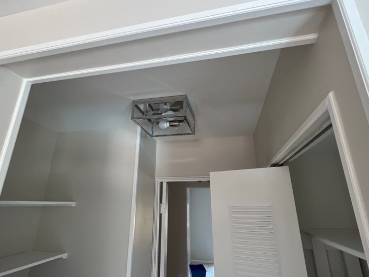 Updated Grey Pantry with High Contrast White Trim and Chrome Lighting