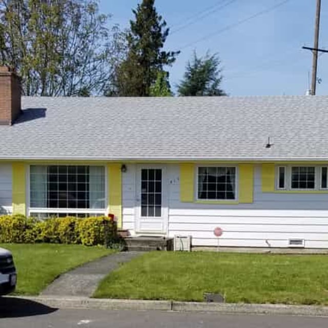 Single Story exterior home with white car in front