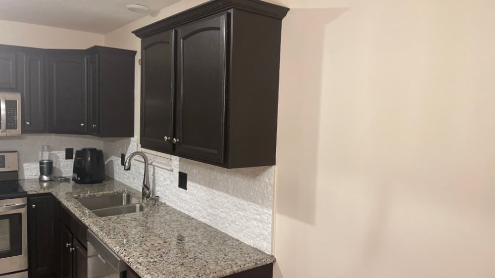 White backsplash offsets dark cabinets