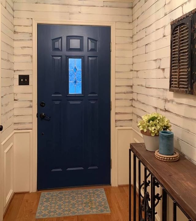 white room with blue front door