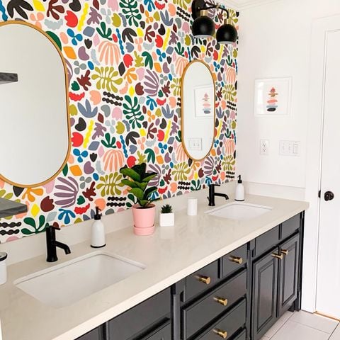 bathroom sinks with a decorative wall