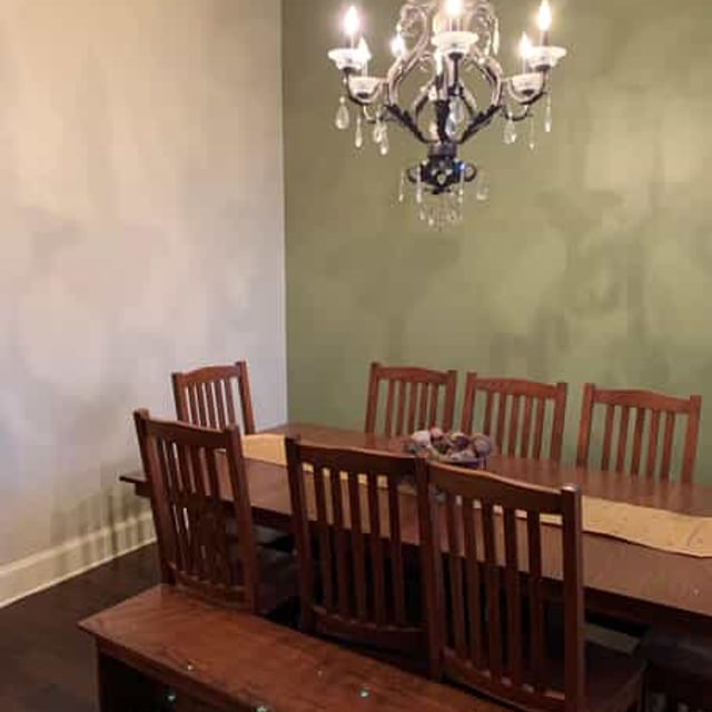 brown dining room table and green wall