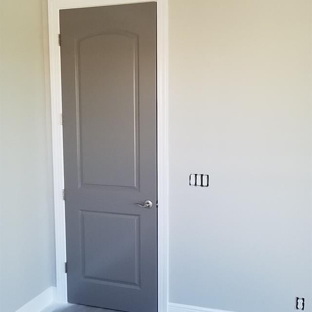 brown door in a room being repainted