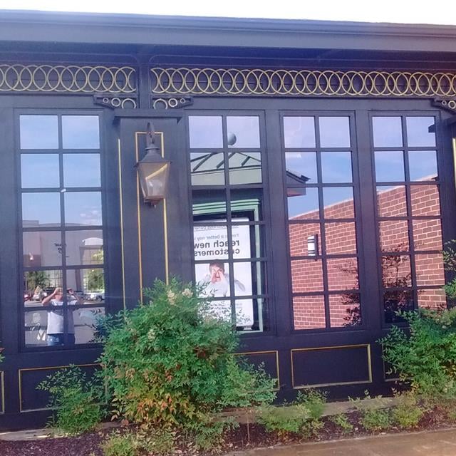 dark painted exterior doors for retail shop with a gold trim