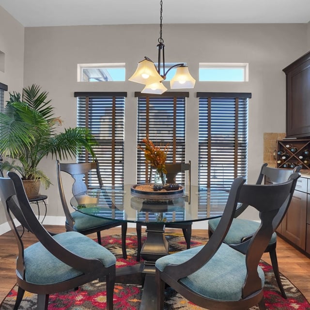 dining room with glass table and blue chairs