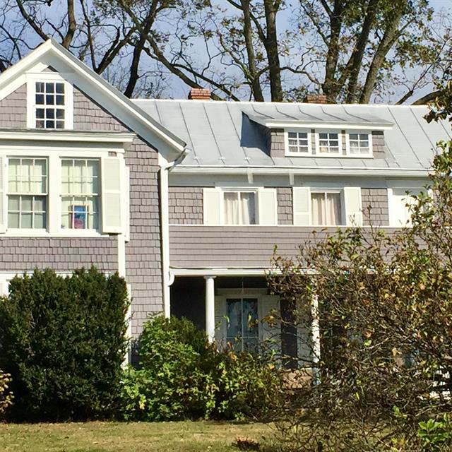 exterior of home with grey shaker siding and white contrasting trim